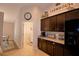Kitchen with dark cabinetry, granite countertops, tile backsplash, and stainless steel appliances at 186 Viola Dr, Auburndale, FL 33823