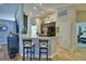 Open kitchen features a breakfast bar, tile floors, stainless appliances, and modern decor at 186 Viola Dr, Auburndale, FL 33823