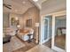 Comfortable living room with vaulted ceilings, neutral color palette, and sliding glass doors to office at 186 Viola Dr, Auburndale, FL 33823