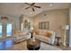Bright living room with vaulted ceilings, ceiling fan, two white sofas, area rug, and decor at 186 Viola Dr, Auburndale, FL 33823