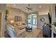 Open-concept living room with neutral tones, vaulted ceiling, comfortable seating, and stylish decor at 186 Viola Dr, Auburndale, FL 33823