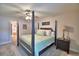 Bedroom with a four-poster bed, side table, and view into the main bathroom at 186 Viola Dr, Auburndale, FL 33823