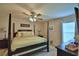 Main bedroom featuring a four-poster bed, ceiling fan, and neutral decor at 186 Viola Dr, Auburndale, FL 33823