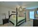 Comfortable bedroom showcasing a four-poster bed and a ceiling fan at 186 Viola Dr, Auburndale, FL 33823