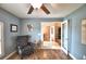 Comfortable office space with a leather chair, wood floors, ceiling fan and view into the dining room at 186 Viola Dr, Auburndale, FL 33823