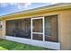 Screened patio with grill, ceiling fan, and view of the back yard at 186 Viola Dr, Auburndale, FL 33823