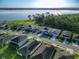 Aerial view showcasing homes near a lake, some with solar panels, illustrating a sustainable community near the water at 225 Summershore Dr, Auburndale, FL 33823