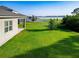 A spacious backyard with a view of a serene lake, creating a peaceful and picturesque outdoor space at 225 Summershore Dr, Auburndale, FL 33823