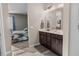 Bathroom featuring tiled floors, a double vanity and a view of the bedroom through an open doorway at 225 Summershore Dr, Auburndale, FL 33823