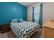 Cozy bedroom featuring a bright blue accent wall, curtains and warm interior lighting at 225 Summershore Dr, Auburndale, FL 33823