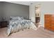 Comfortable bedroom with carpet, dresser and views of the bathroom through an open doorway at 225 Summershore Dr, Auburndale, FL 33823