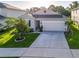 Exterior shot of a gray one-story house with a well-maintained yard at 225 Summershore Dr, Auburndale, FL 33823