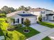 Charming single-story home with well-maintained lawn, landscaped garden beds, and concrete driveway at 225 Summershore Dr, Auburndale, FL 33823