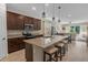 Modern kitchen with granite countertops, stainless steel appliances, dark wood cabinetry, and island with seating at 225 Summershore Dr, Auburndale, FL 33823