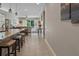 Kitchen showcasing granite countertops, island seating, and tile flooring flowing into a large open living space at 225 Summershore Dr, Auburndale, FL 33823