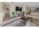 Bright living room with entertainment center, neutral walls, carpet, and an open layout, perfect for gatherings at 225 Summershore Dr, Auburndale, FL 33823