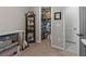 A room with a display case filled with porcelain dolls and a walk-in closet full of boxes and plastic bins at 225 Summershore Dr, Auburndale, FL 33823