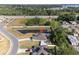 An aerial view showcases a single-Gathering home with a private pond and a spacious backyard at 230 Cove At Eagle Lake Cir, Eagle Lake, FL 33839
