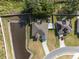 An aerial view showcases a single-Gathering home with a private pond and a spacious backyard at 230 Cove At Eagle Lake Cir, Eagle Lake, FL 33839