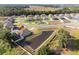 An aerial view showcases a single-Gathering home with a private pond and a spacious backyard at 230 Cove At Eagle Lake Cir, Eagle Lake, FL 33839