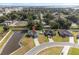 An aerial view showcases a single-Gathering home with a private pond and a spacious backyard at 230 Cove At Eagle Lake Cir, Eagle Lake, FL 33839