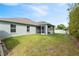 Expansive backyard featuring lawn, storage sheds, and screened in patio at 230 Cove At Eagle Lake Cir, Eagle Lake, FL 33839