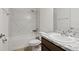 Bathroom featuring marble style tiled shower and backsplash and granite countertop sink at 230 Cove At Eagle Lake Cir, Eagle Lake, FL 33839