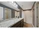 Stylish bathroom with granite countertops, a large mirror, and a walk-in shower at 230 Cove At Eagle Lake Cir, Eagle Lake, FL 33839