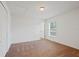 This bedroom boasts a closet, natural light from a window, and neutral carpet flooring at 230 Cove At Eagle Lake Cir, Eagle Lake, FL 33839