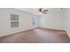 Bright bedroom with two windows, neutral carpeting, and ample natural light at 230 Cove At Eagle Lake Cir, Eagle Lake, FL 33839