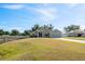 Charming single-story home with a well-manicured lawn and attached two-car garage at 230 Cove At Eagle Lake Cir, Eagle Lake, FL 33839