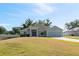 Charming single-story home with a well-manicured lawn and attached two-car garage at 230 Cove At Eagle Lake Cir, Eagle Lake, FL 33839