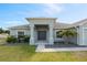 Inviting front entrance with a well-kept lawn, shrubbery and fresh exterior paint at 230 Cove At Eagle Lake Cir, Eagle Lake, FL 33839