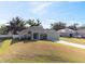 Charming single-story home featuring a well-manicured lawn and a two-car garage at 230 Cove At Eagle Lake Cir, Eagle Lake, FL 33839