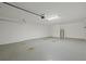 Large garage with clean epoxy flooring, ample room for parking at 230 Cove At Eagle Lake Cir, Eagle Lake, FL 33839