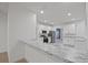 Modern kitchen features stainless steel appliances, granite countertops, and white cabinetry at 230 Cove At Eagle Lake Cir, Eagle Lake, FL 33839