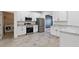 Modern kitchen with stainless steel appliances and granite counters next to laundry room at 230 Cove At Eagle Lake Cir, Eagle Lake, FL 33839