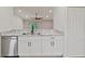 Bright kitchen features stainless steel appliances, granite countertops, and white cabinets at 230 Cove At Eagle Lake Cir, Eagle Lake, FL 33839
