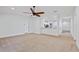 Open-concept living room with a ceiling fan and a view of the kitchen at 230 Cove At Eagle Lake Cir, Eagle Lake, FL 33839