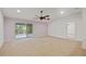 Spacious living room with a ceiling fan and sliding glass doors leading to the outdoor area at 230 Cove At Eagle Lake Cir, Eagle Lake, FL 33839