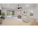 Bright and airy living room with sliding glass doors leading to a screened in patio at 230 Cove At Eagle Lake Cir, Eagle Lake, FL 33839