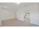 Open-concept living space with fresh white paint and plush carpet flooring at 230 Cove At Eagle Lake Cir, Eagle Lake, FL 33839