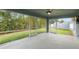 Relaxing screened-in patio featuring ceiling fan and views of the well-maintained backyard at 230 Cove At Eagle Lake Cir, Eagle Lake, FL 33839