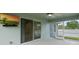 Spacious screened-in patio is perfect for entertaining with mounted TV and outdoor access at 230 Cove At Eagle Lake Cir, Eagle Lake, FL 33839