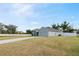 A single-story home boasting an expansive driveway and a well-maintained lawn at 230 Cove At Eagle Lake Cir, Eagle Lake, FL 33839
