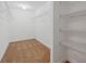 Spacious walk-in closet with ample shelving and neutral carpeting at 230 Cove At Eagle Lake Cir, Eagle Lake, FL 33839