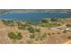 Aerial view showing the house nestled in a green area near a lake and other residential properties at 2390 Lake Easy Rd, Babson Park, FL 33827