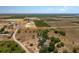 Wide aerial view of the property with rows of farmland and a lake visible in the backdrop at 2390 Lake Easy Rd, Babson Park, FL 33827