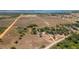 Aerial view of the home surrounded by trees with agricultural fields and lakes in the distance at 2390 Lake Easy Rd, Babson Park, FL 33827