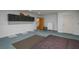 Finished basement features ample storage, a staircase, access door, painted floor, and carpet at 2390 Lake Easy Rd, Babson Park, FL 33827